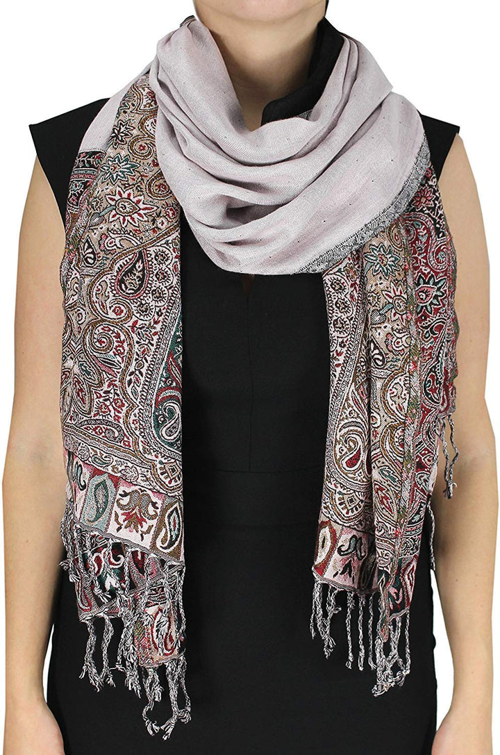 Reversible white pashmina wrap with a vibrant bohemian paisley pattern, double-layered fabric, and traditional fringed edges.