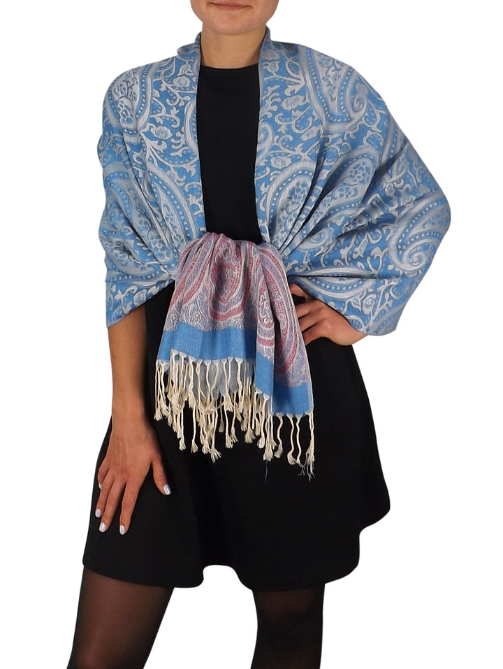Large pashmina shawl featuring an intricate blue and cream vintage vine paisley print with fringed edges.