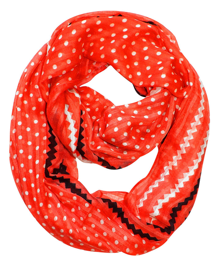 Vibrant red infinity loop scarf featuring a stylish white polka dot and chevron pattern in a lightweight sheer fabric.