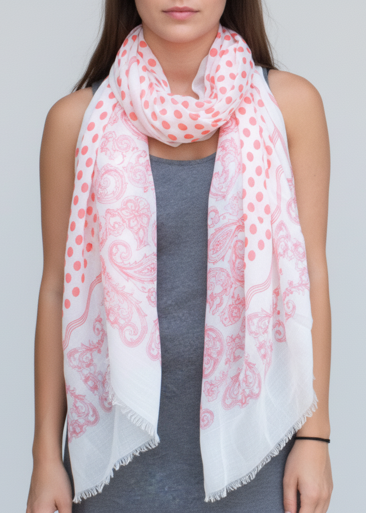 Lightweight coral gauze pashmina scarf with a decorative paisley border, polka dot center, and soft eyelash fringe.