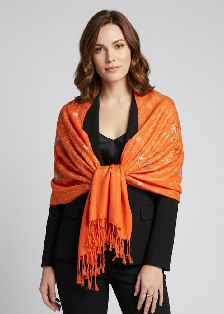 Elegant orange pashmina shawl featuring intricate hand-embroidered floral patterns and a decorative fringe border.