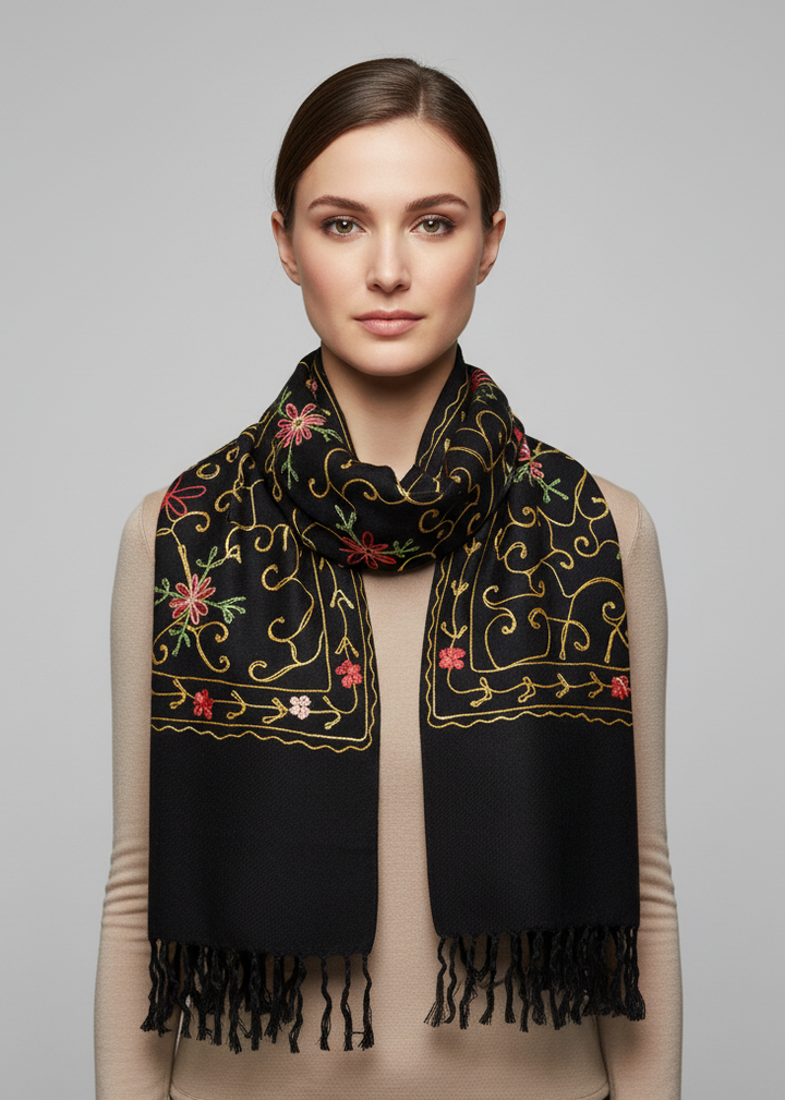 Hand-embroidered floral patterns on a soft wool pashmina shawl with decorative fringe edges