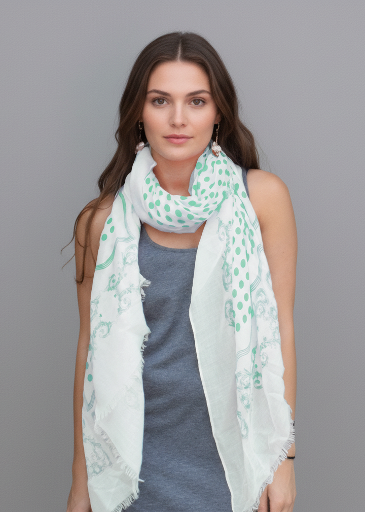 Lightweight mint green pashmina scarf with a paisley border and polka dot center featuring eyelash fringe.