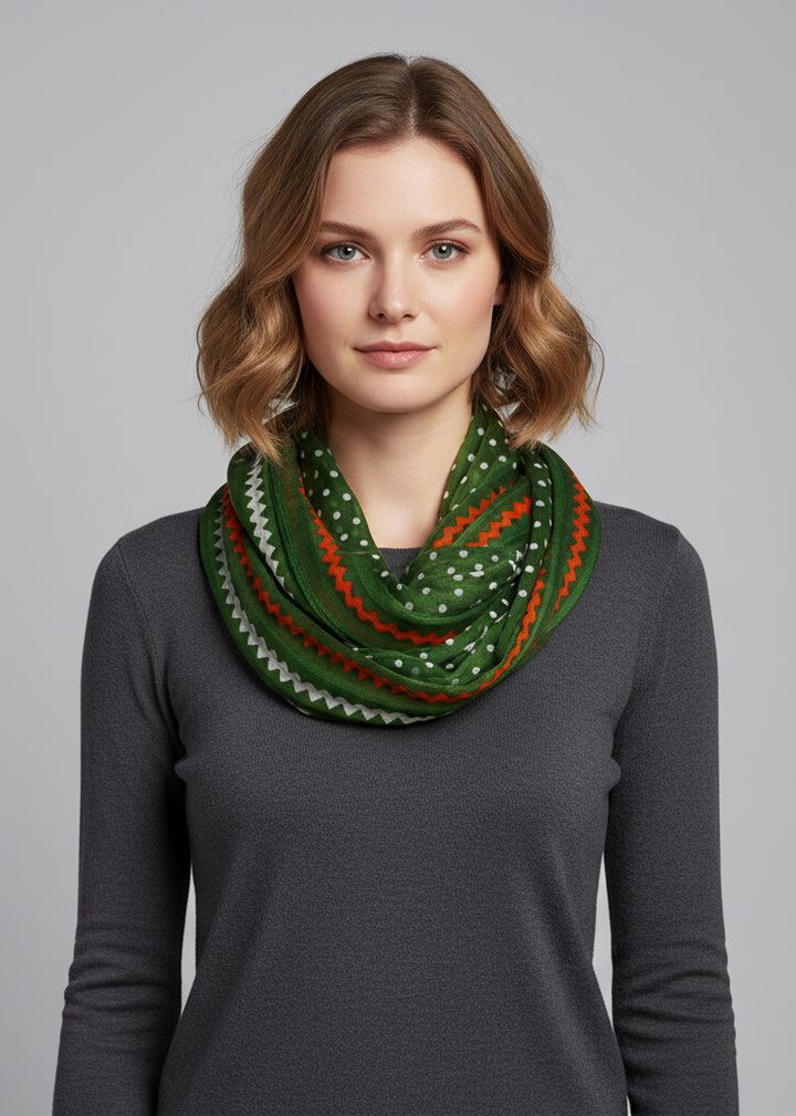 Green sheer infinity loop scarf featuring a white polka dot and chevron pattern.
