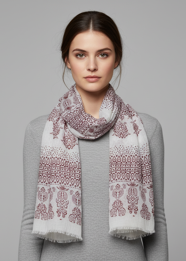 Wine colored scarf with an intricate henna-inspired paisley print and delicate eyelash fringe trim