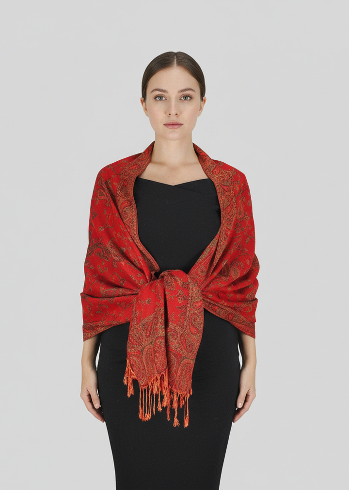 Double layer reversible pashmina shawl featuring an intricate paisley pattern in red and gold with delicate fringe trim.