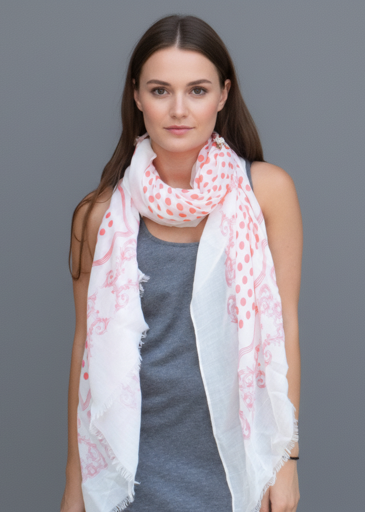 Vibrant coral pink and white polka dot scarf with an elegant paisley border and soft eyelash fringe.