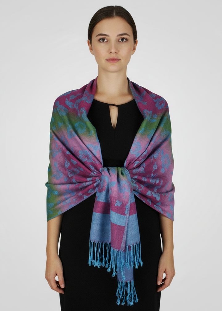 Rainbow silky tropical Hawaiian pansy pashmina wrap shawl scarf in teal with floral patterns and fringed edges.