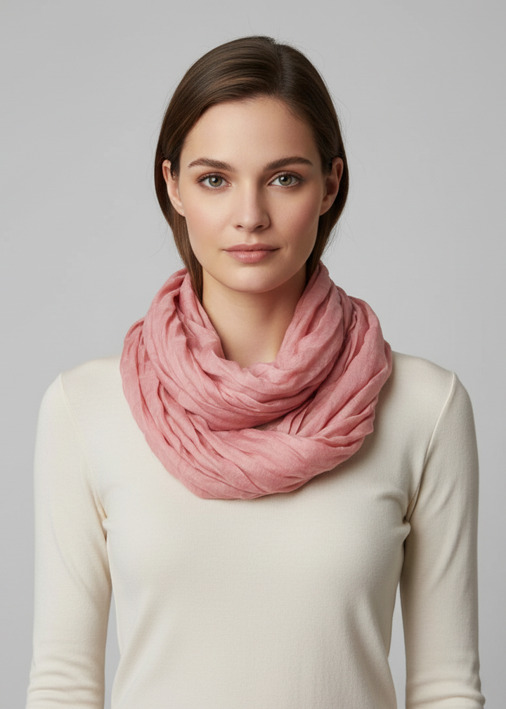 Solid dusty rose crinkled infinity loop scarf in lightweight viscose for seasonal layering.