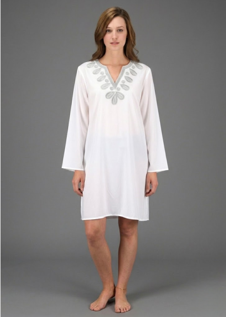 White cotton boho beach cover-up tunic featuring silver floral embroidery, a V-neckline, and a relaxed fit with a fringed hem.