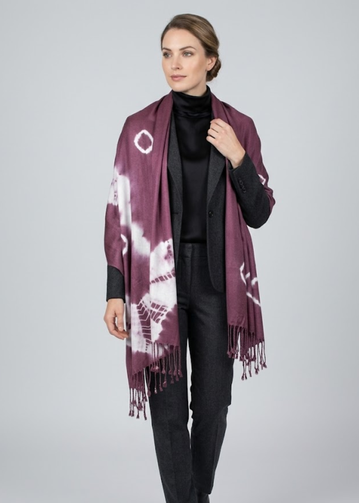 Vibrant multi-colored tie-dye pashmina shawl with decorative fringe edges and soft fabric texture