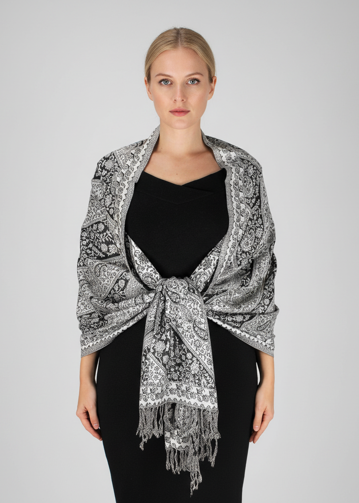 Elegant double-layer reversible pashmina shawl featuring a classic black and white paisley pattern with delicate fringed edges.