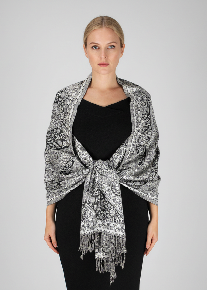Elegant double-layer reversible pashmina shawl featuring a classic black and white paisley pattern with delicate fringed edges.