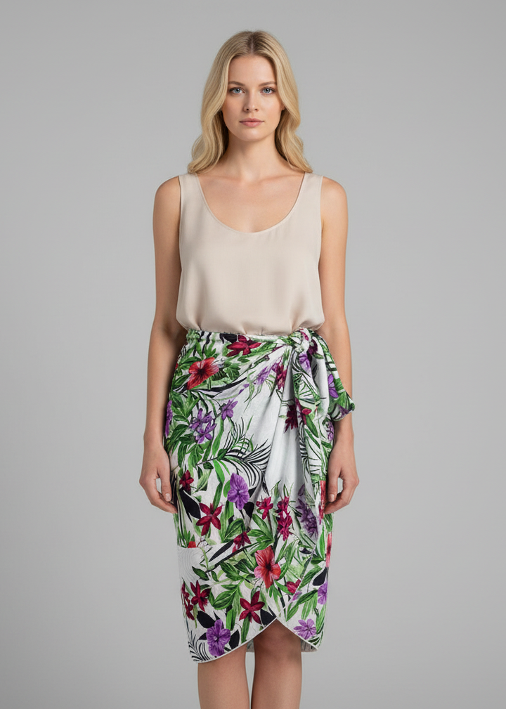 White women's Hawaiian pareo sarong beach wrap featuring a tropical white floral hibiscus and heliconia print on a clean white background.