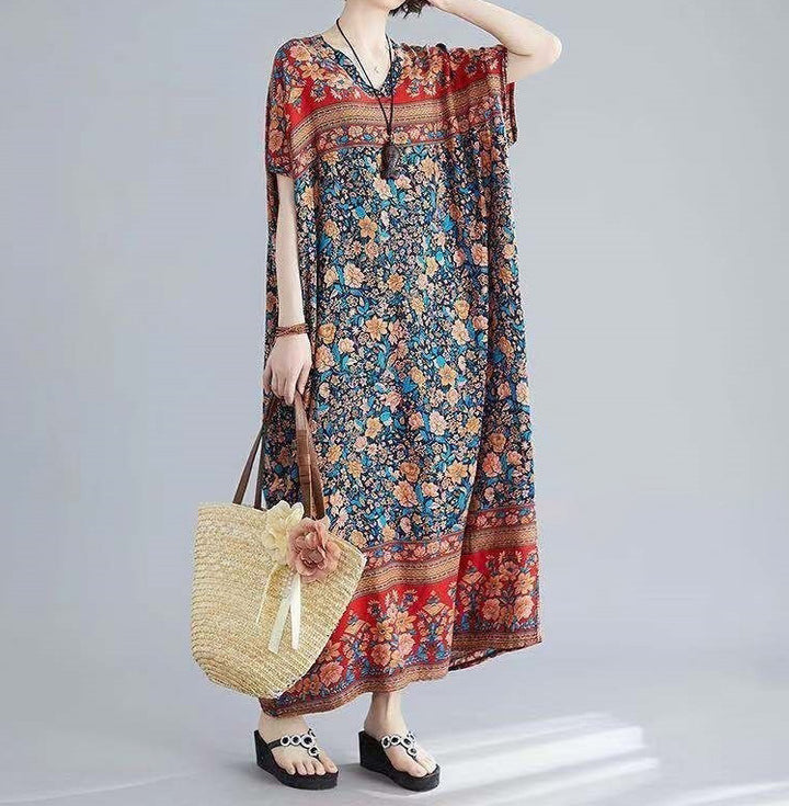 Bohemian floral kaftan dress for women styled as elegant home loungewear; a lightweight, full-length summer maxi dress with a Mediterranean-inspired floral pattern.