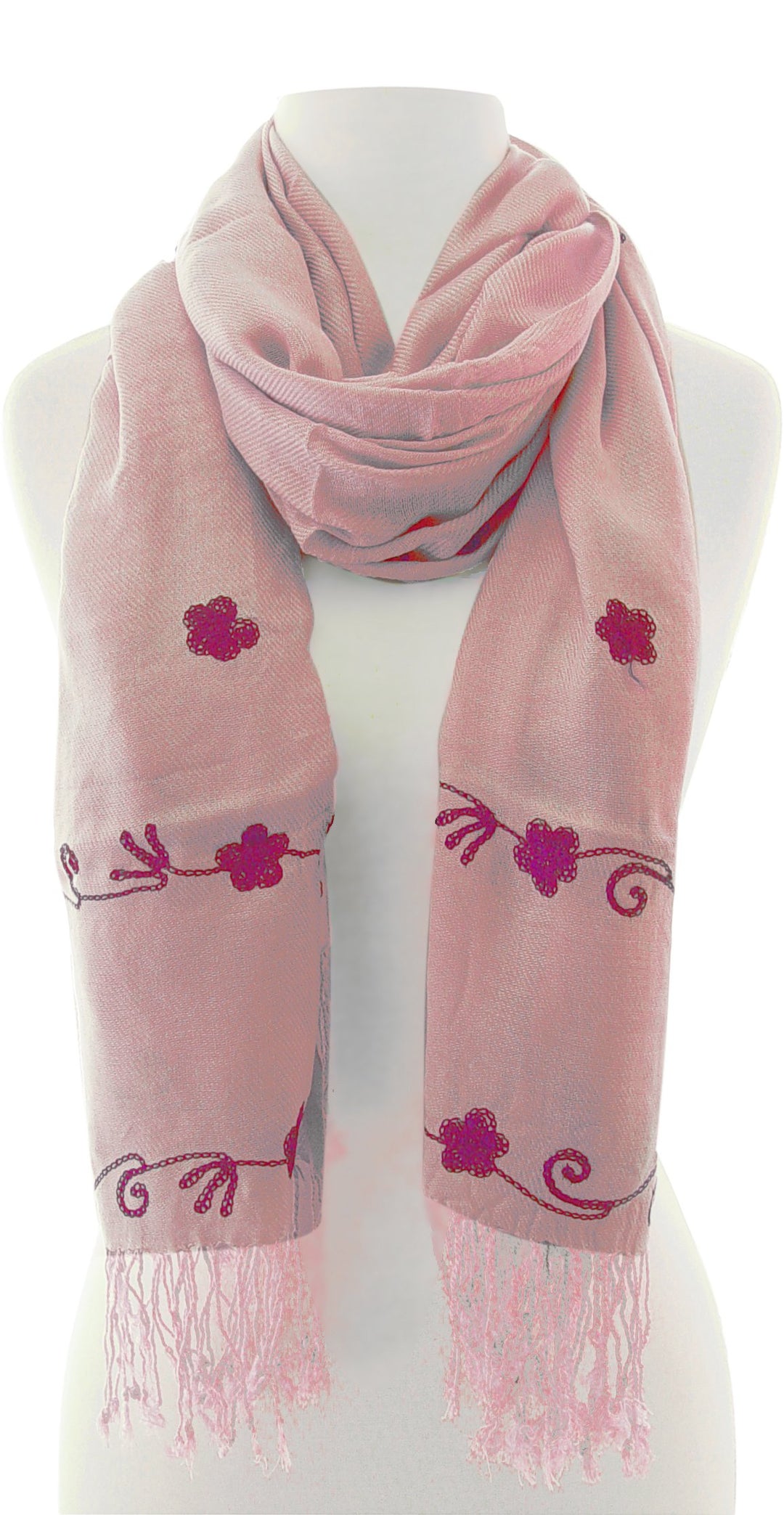 Intricate floral embroidery on a lightweight summer shawl with decorative fringe edges and a bohemian style design.