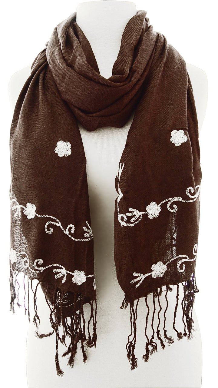 Delicate floral embroidery on a lightweight summer shawl scarf with fine fringe detailing