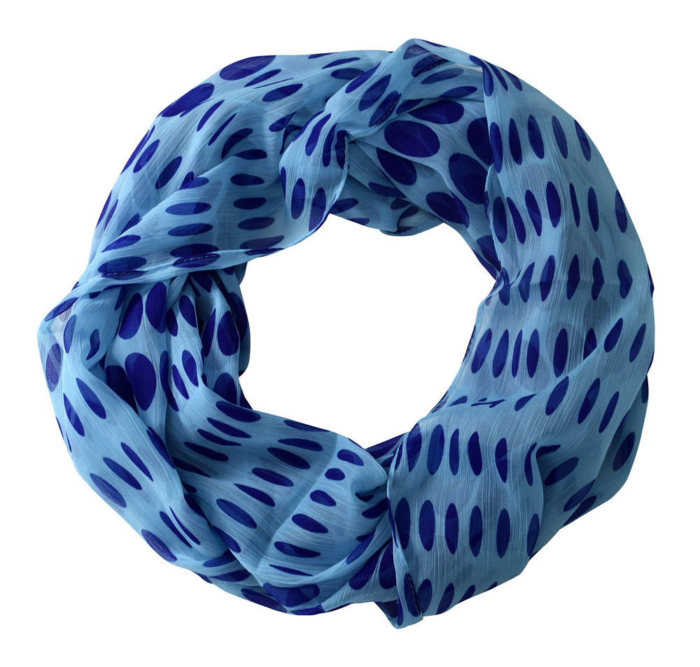 Lightweight and sheer cream infinity loop scarf featuring a black speckled polka dot and circle print.