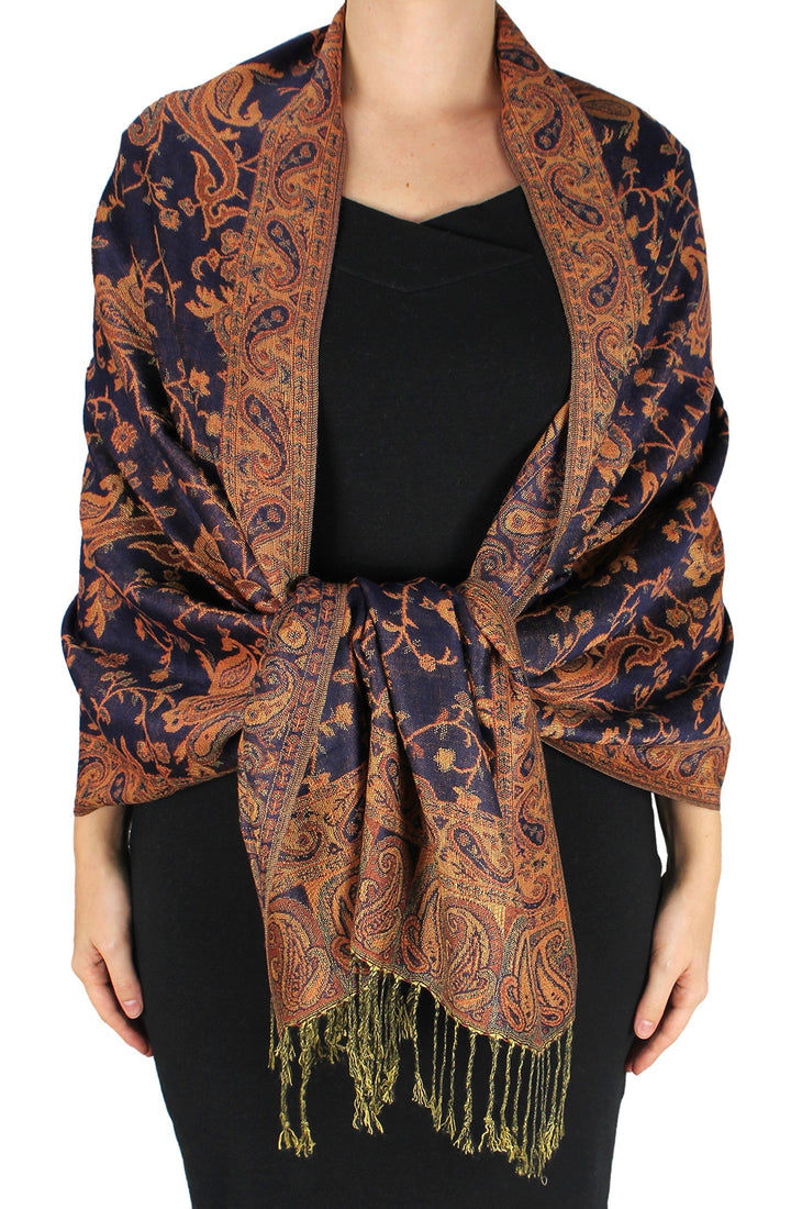 Reversible jacquard pashmina shawl featuring an intricate paisley pattern in navy blue and burnt orange with fringed ends.